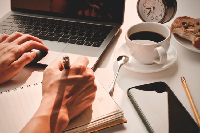 A person writing on a notebook