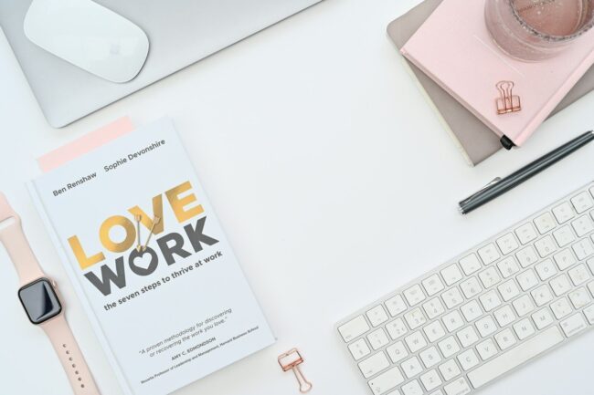 a book sitting on top of a desk next to a keyboard
